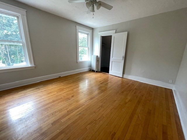 44 Boardman Street Worcester, MA 01606 - Photo 22 of 29 a view of an empty room with wooden floor and a window