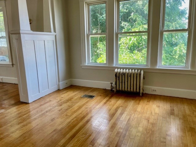 44 Boardman Street Worcester, MA 01606 - Photo 5 of 29 a view of an empty room with wooden floor and a window