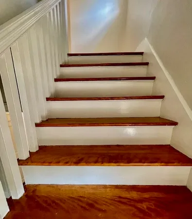 a view of staircase with wooden floor