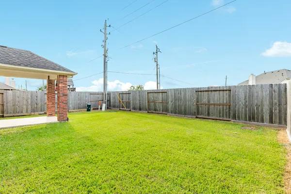 a swimming pool with yard and outdoor seating