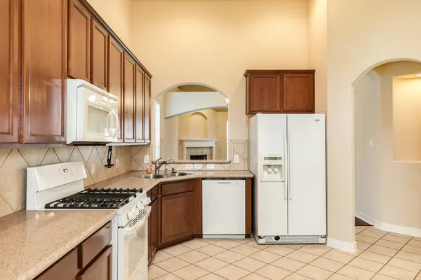 a kitchen with a sink cabinets and appliances