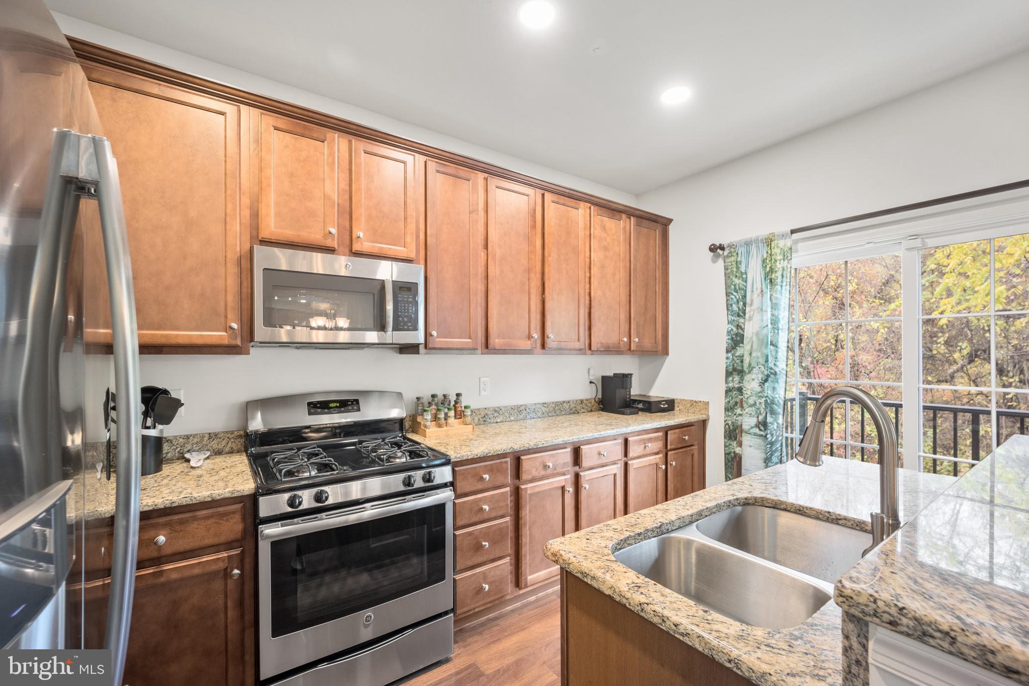 151 Creekside Way Burlington, NJ 08016 - Photo 8 of 35 a kitchen with granite countertop a sink and a stove top oven