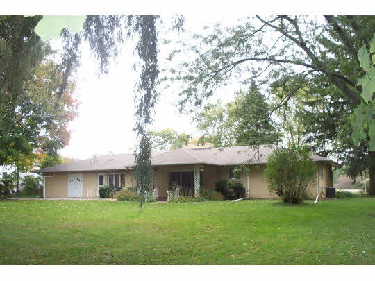 2990 Reid Farm Road Rockford, IL 61114 - Photo 9 of 11 a view of a big house with a big yard and large trees