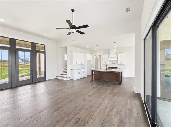 a view of kitchen island with furniture wooden floor and windows