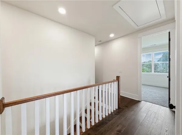 a view of a big room with windows and chandelier fan
