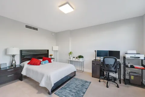 a bedroom with a bed and a desk