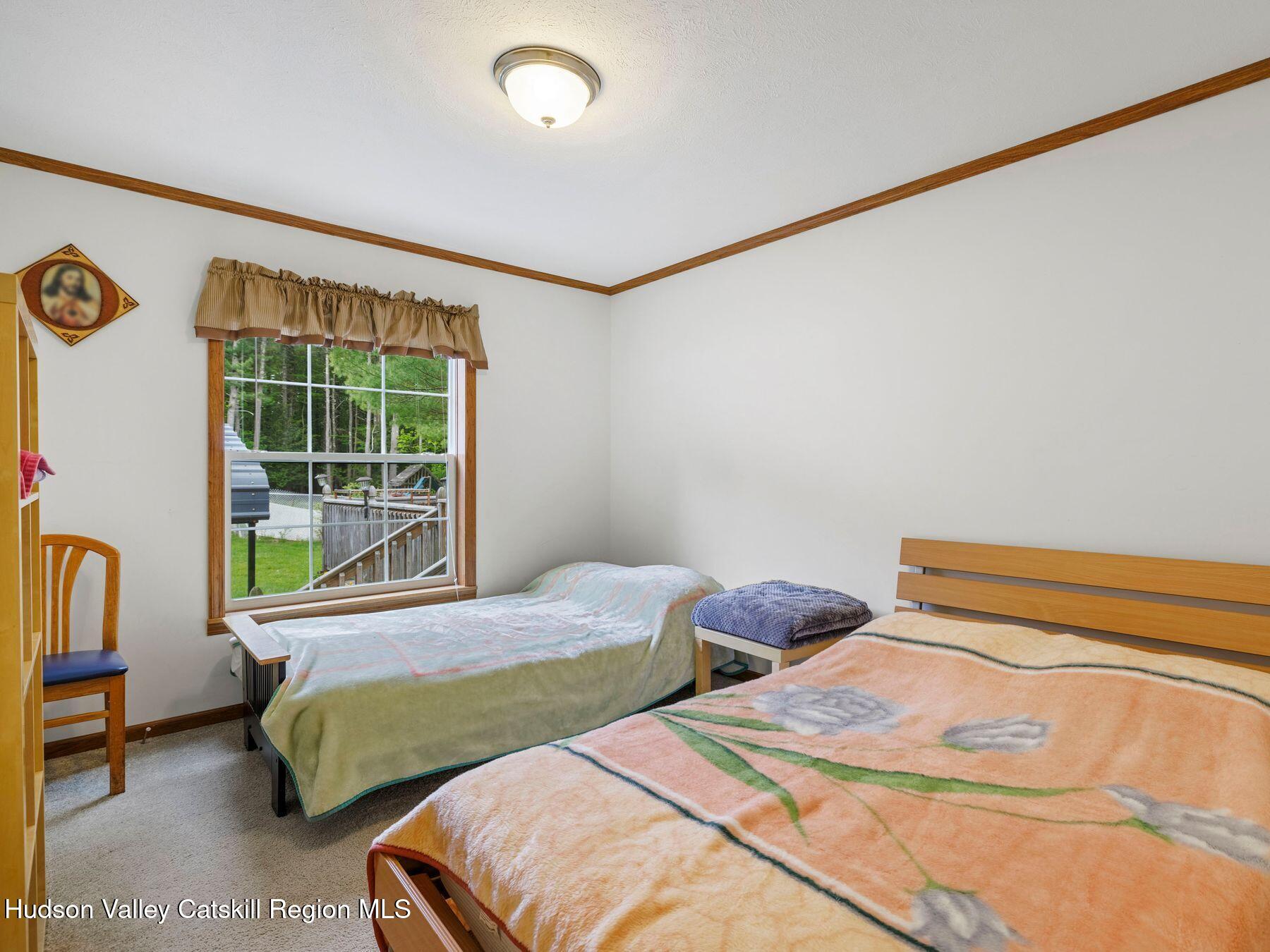 137 Mountain Pond View Road Gilboa, NY 12076 - Photo 34 of 38 a bedroom with two beds and a large window