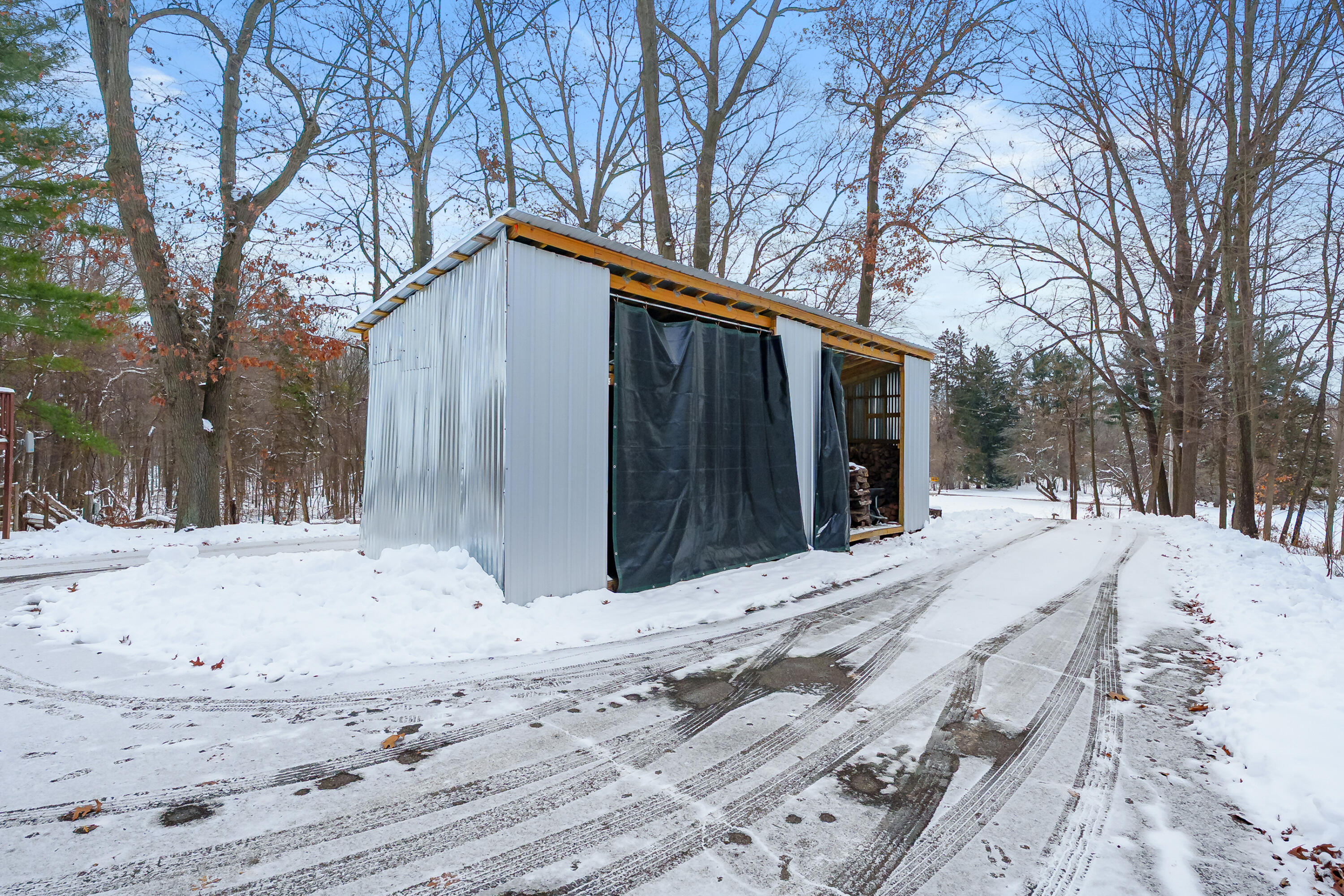 13950 Brady Road Bellevue, MI 49021 - Photo 31 of 49 Wood shed stocked for winter warmth