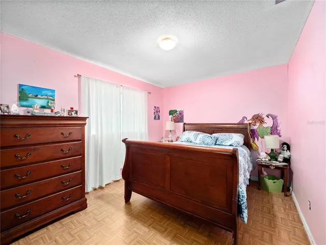 a bed room with a bed and a television