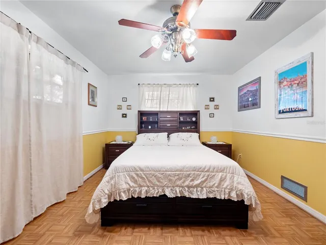 a bedroom with a bed and a chandelier