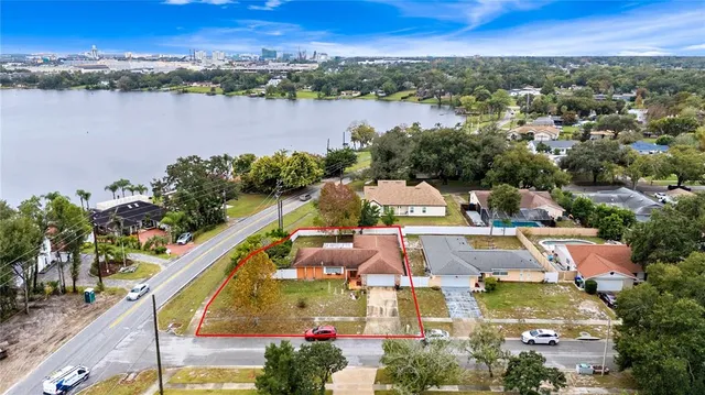 an aerial view of residential houses with outdoor space and lake view