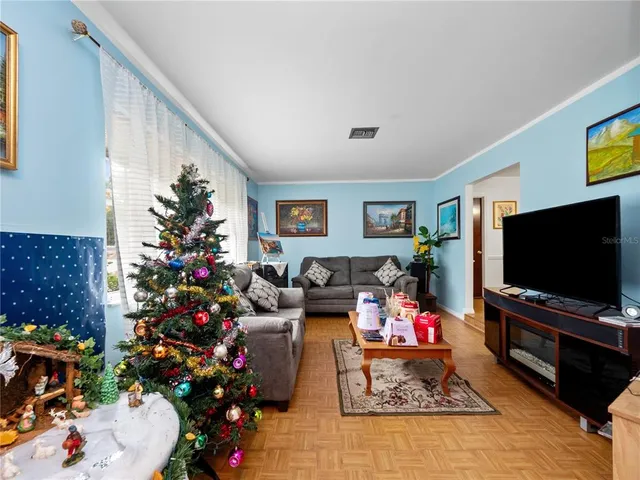 a living room with furniture and a flat screen tv