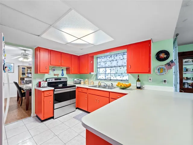 a kitchen with stainless steel appliances kitchen island granite countertop a stove a sink and a microwave