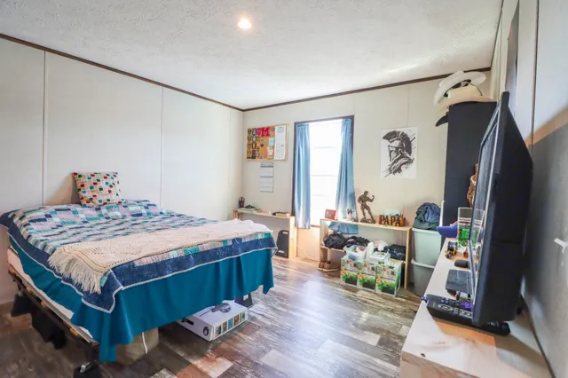 a bed sitting in a bedroom next to a window