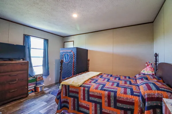 a bedroom with a bed and a mirror