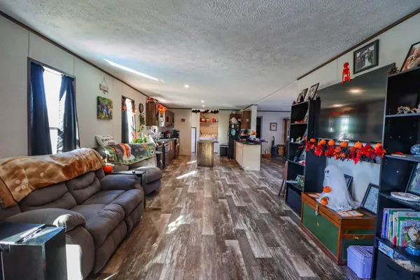a living room with furniture and a wooden floor
