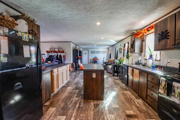 a utility room with fridge and closet