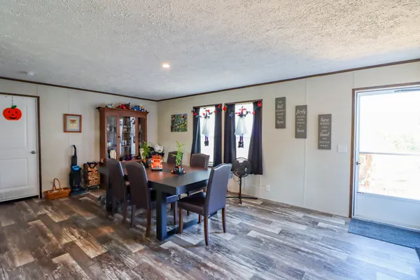 a view of a dining room with furniture and wooden floor