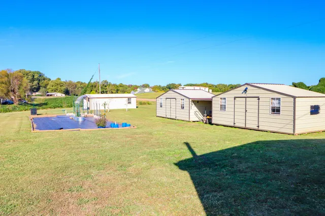 a view of backyard of house with seating space