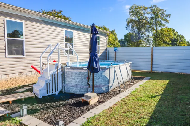 a view of a house with backyard and sitting area