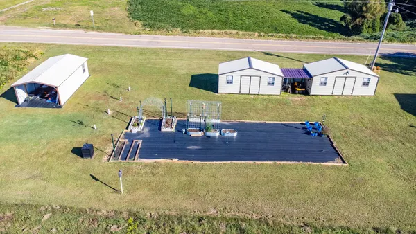 an aerial view of a house with a yard