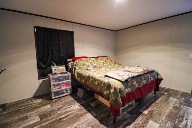 a bedroom with a bed and a dresser