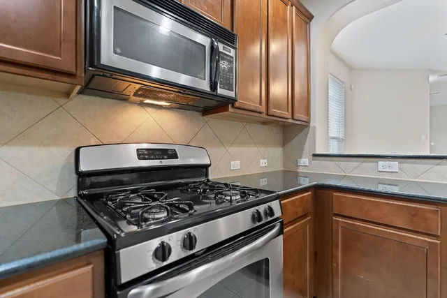 a stove top oven sitting inside of a kitchen