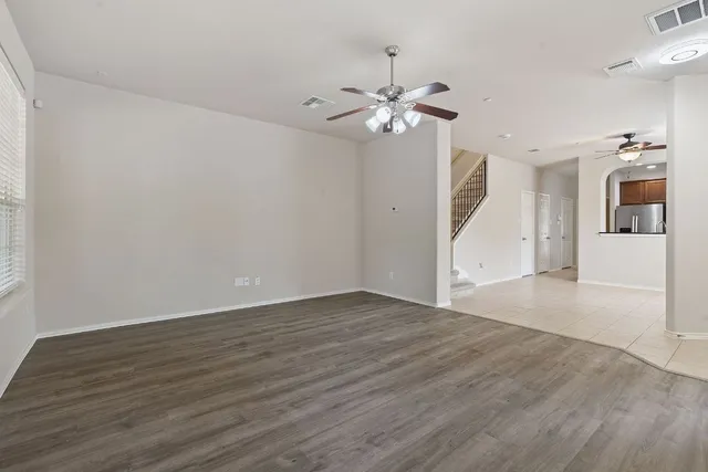 a view of a livingroom with wooden floor and cabinet