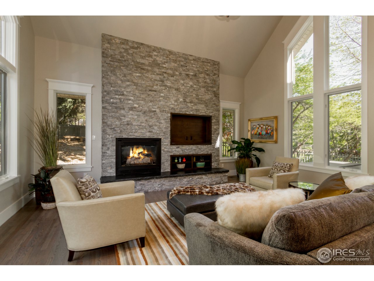 3551 4th Street Boulder, CO 80304 - Photo 6 of 38 a living room with couches a fireplace and a flat screen tv