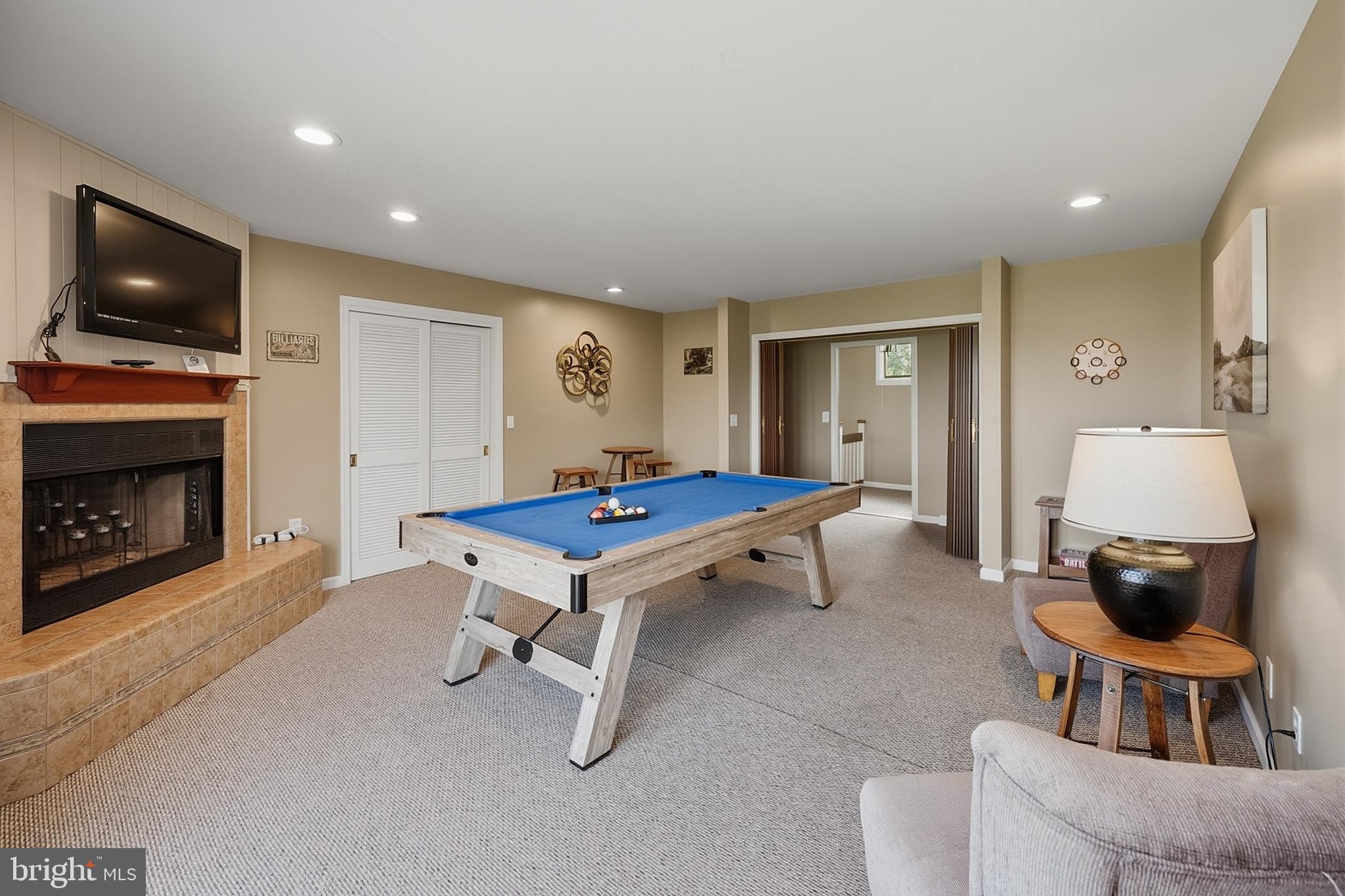 467 Paradise Ridge Road Oakland, MD 21550 - Photo 27 of 64 a living room with furniture pool table flat screen tv and a fireplace