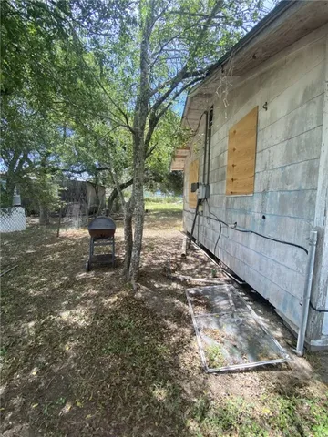 a backyard of a house with table and chairs