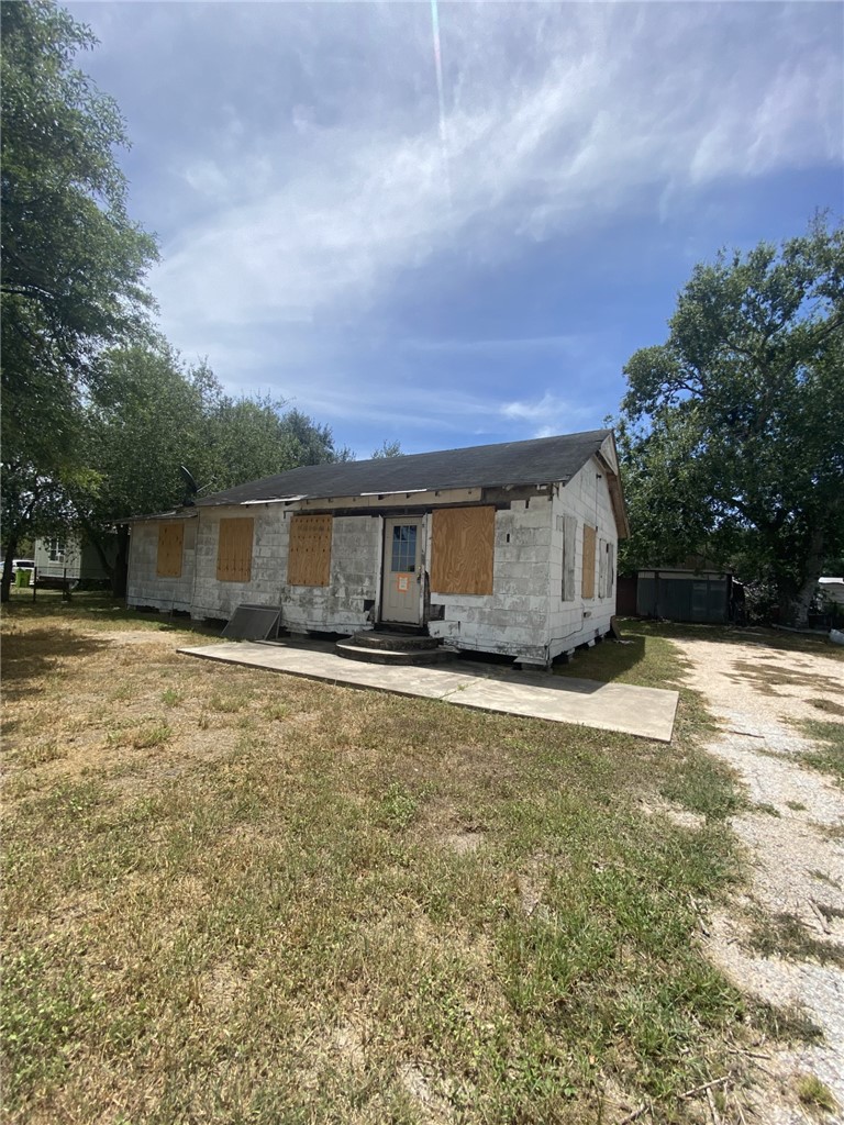 629 Southwest 7th Street Premont, TX 78375 - Photo 2 of 12 a front view of house with yard and trees in the background