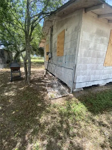 a view of a yard with wooden fence