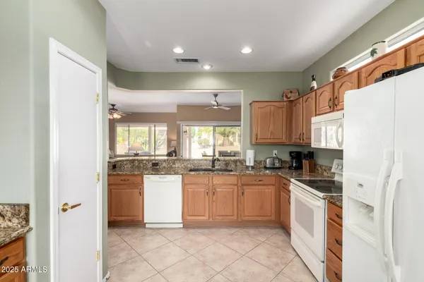 a kitchen with stainless steel appliances granite countertop a stove sink and cabinets