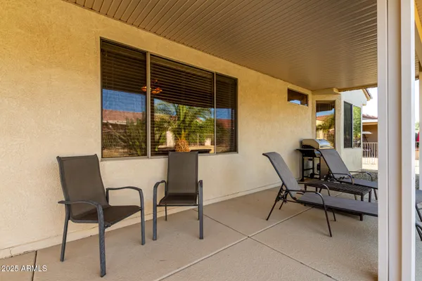 a view of a house with backyard and sitting area