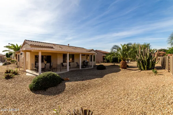 a view of a house with backyard porch and furniture