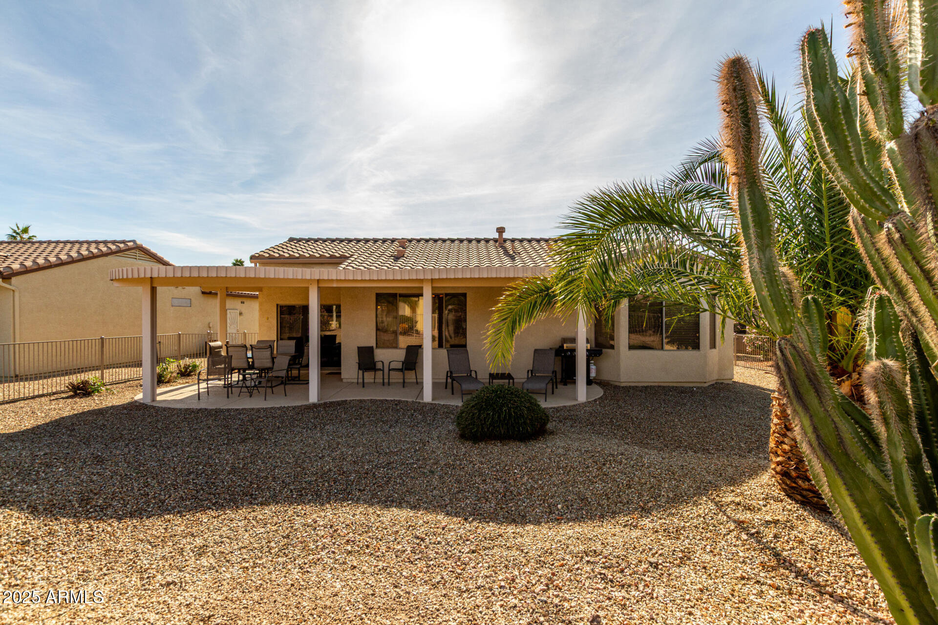 15448 West Moonlight Way Surprise, AZ 85374 - Photo 25 of 26 a view of a house with backyard porch and furniture