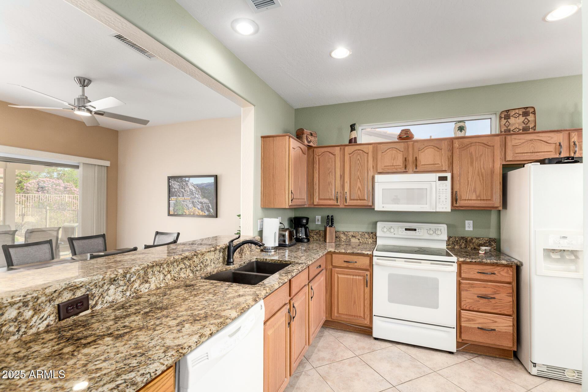 15448 West Moonlight Way Surprise, AZ 85374 - Photo 10 of 26 a kitchen with a sink stove and cabinets