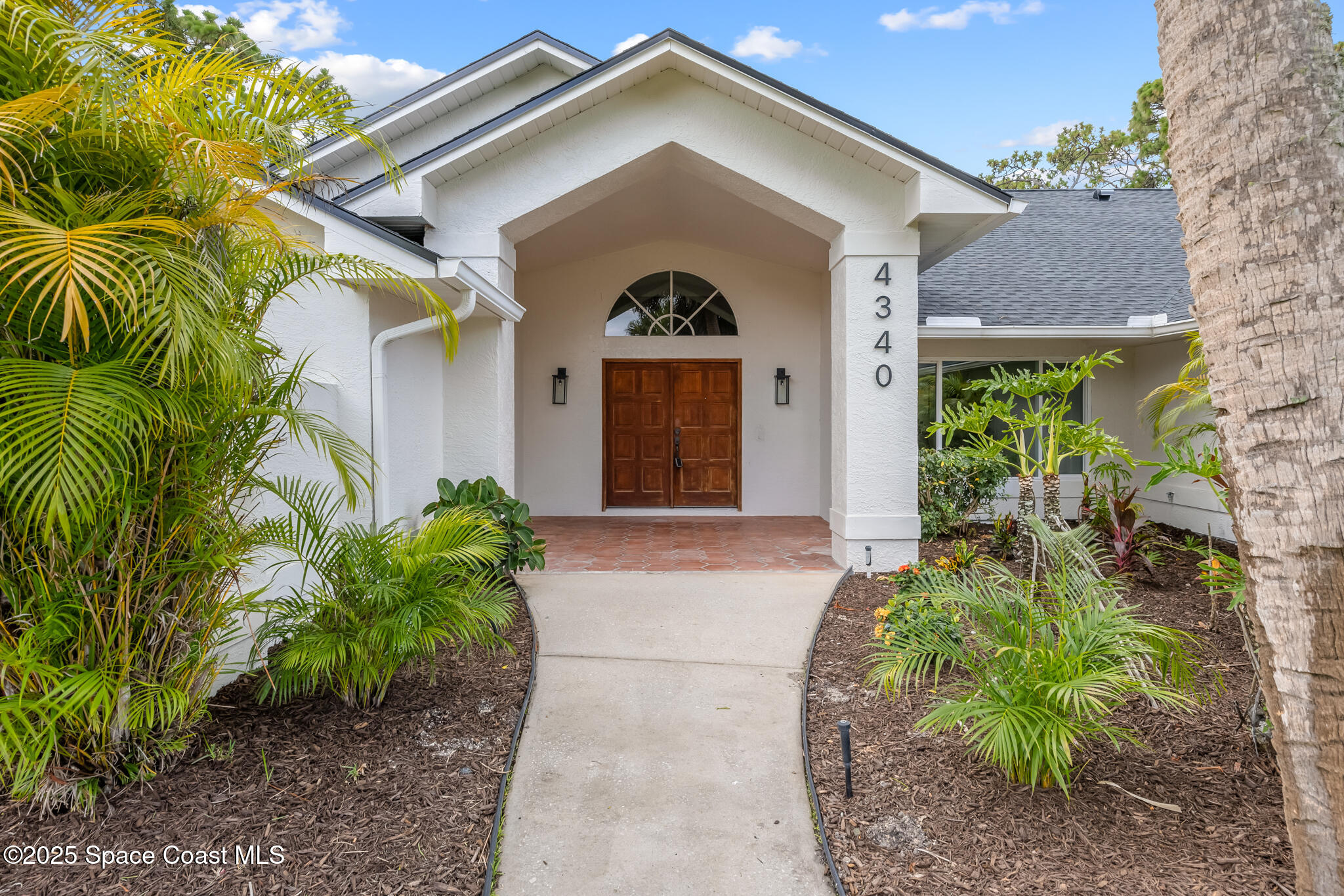 4340 Windover Way Melbourne, FL 32934 - Photo 2 of 42 a front view of a house with a yard