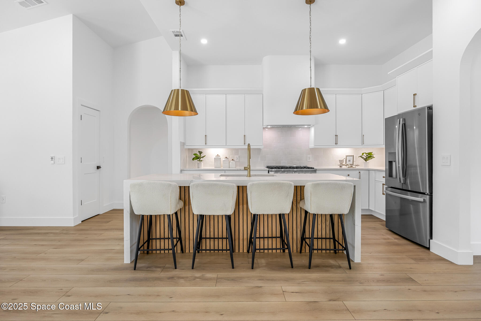 4340 Windover Way Melbourne, FL 32934 - Photo 6 of 42 a kitchen with kitchen island granite countertop wooden floor cabinets and chairs