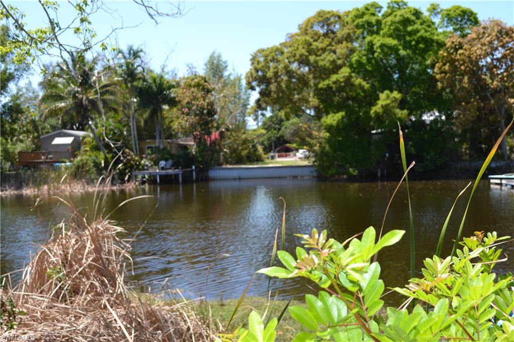3980 New Moon Court Naples, FL 34112 - Photo 2 of 10 a view of a lake with a garden