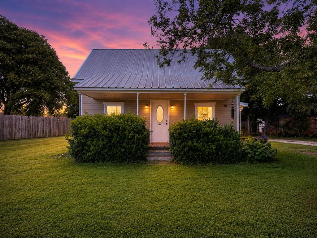 302 Tower Road Rio Vista, TX 76093 - Photo 1 of 29 Front elevation featuring a metal roof, covered porch, and light-toned siding