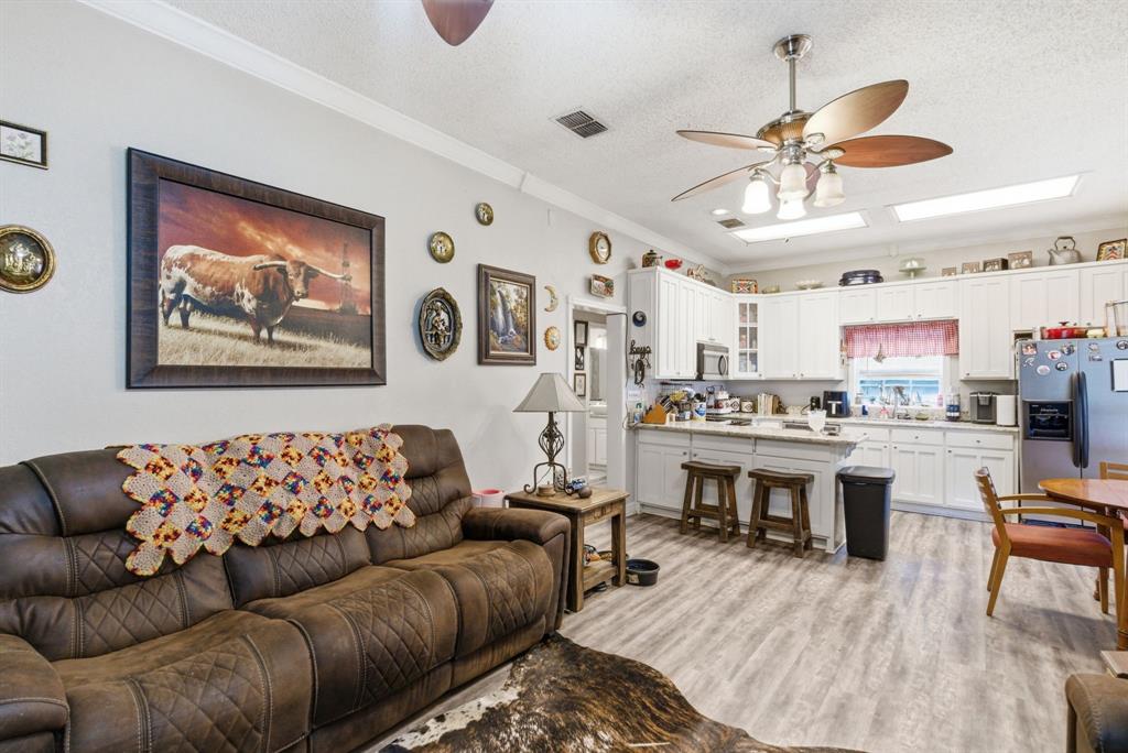 302 Tower Road Rio Vista, TX 76093 - Photo 13 of 29 Open concept living area featuring wood-finish flooring
