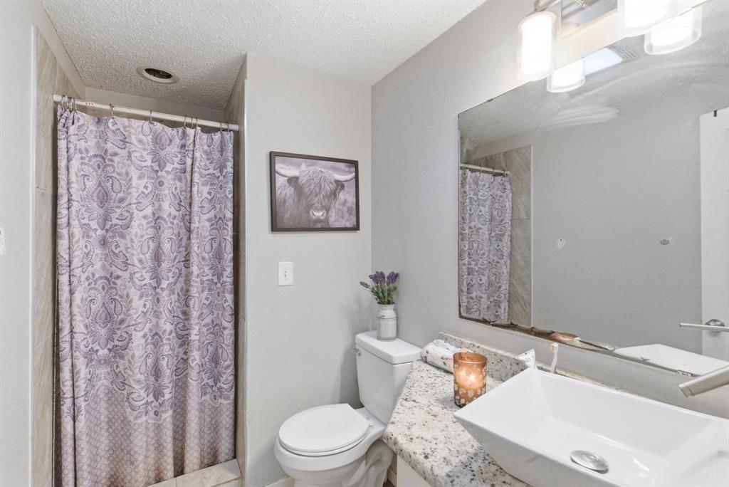 302 Tower Road Rio Vista, TX 76093 - Photo 22 of 29 Bathroom featuring a white rectangular vessel sink, brushed nickel faucet, and a speckled countertop