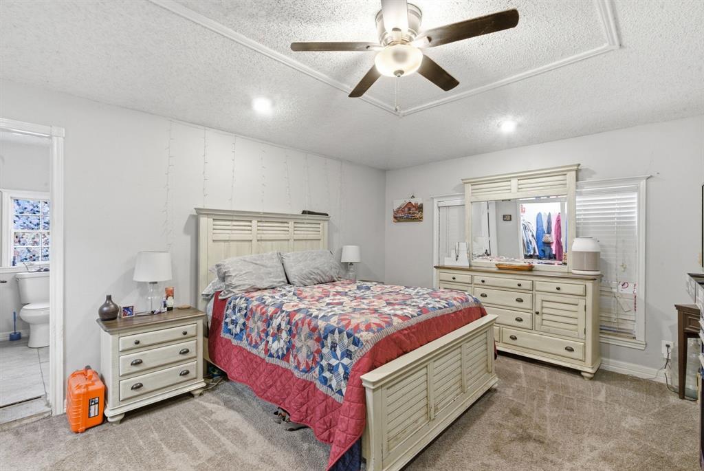302 Tower Road Rio Vista, TX 76093 - Photo 24 of 29 Carpeted room featuring a ceiling fan, recessed lighting, and a doorway opening to a tiled bathroom with a toilet and window