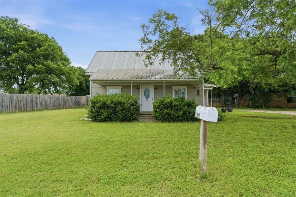 302 Tower Road Rio Vista, TX 76093 - Photo 29 of 29 Single-story residence featuring a metal roof, front porch, and white entry door