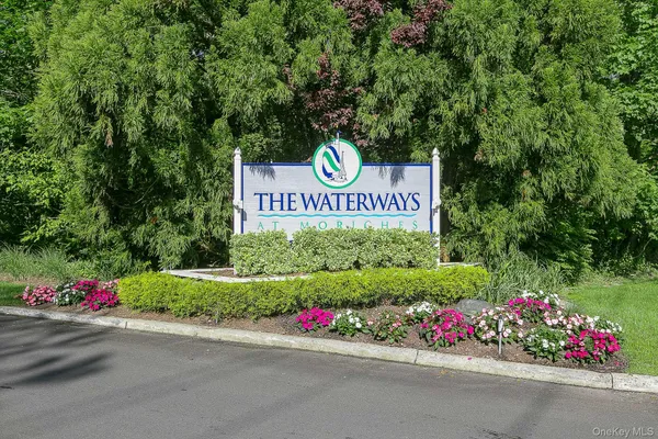 a sign that is sitting in front of flowers