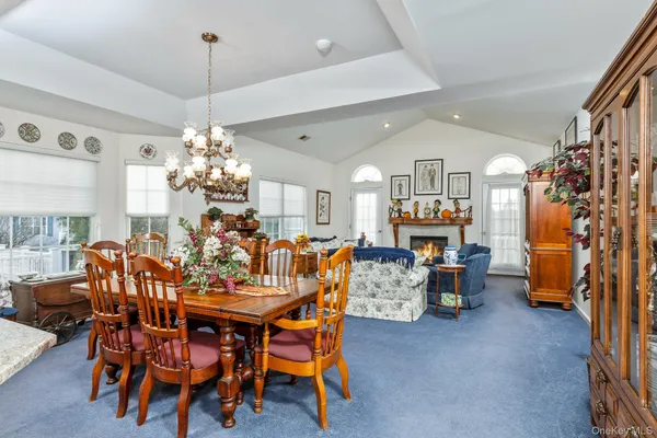 a view of a dining room with furniture and chandelier