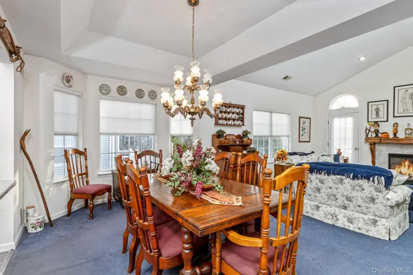 a view of a dining room with furniture and chandelier