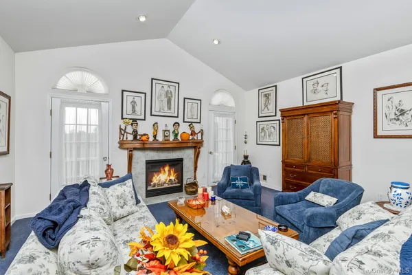 a living room with furniture fireplace and a window